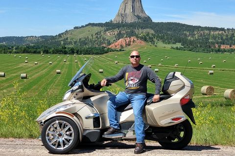 Bryan Ruby sitting on a Can-Am Spyder RT Limited near Devil's Tower