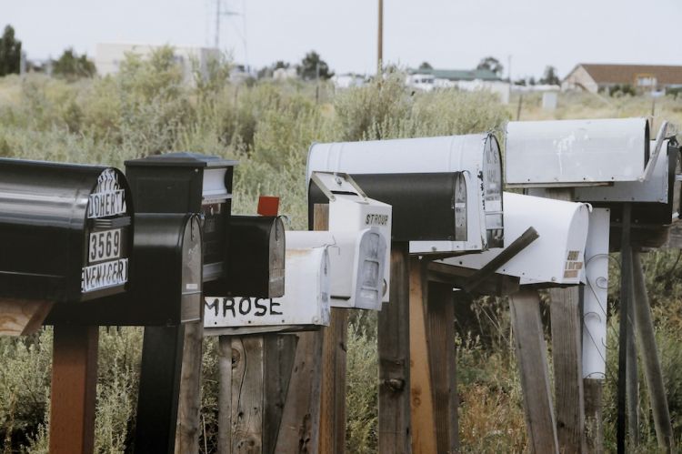 several mailboxes sitting alongside a road