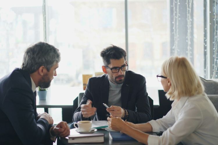 A group of executives sitting around a table and talking
