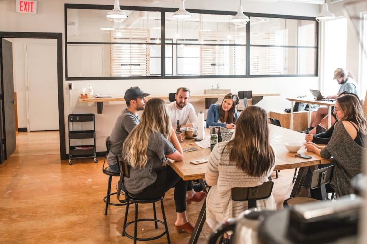 a group of people sitting around a table