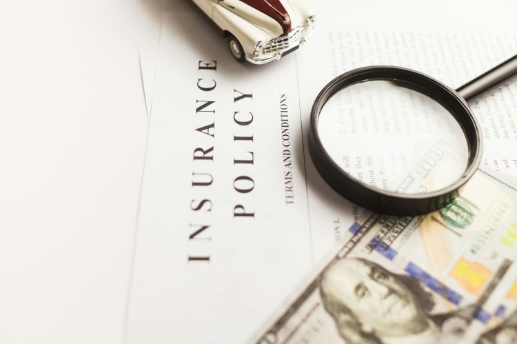 Closeup of a paper with the headline "Insurance Policy"
