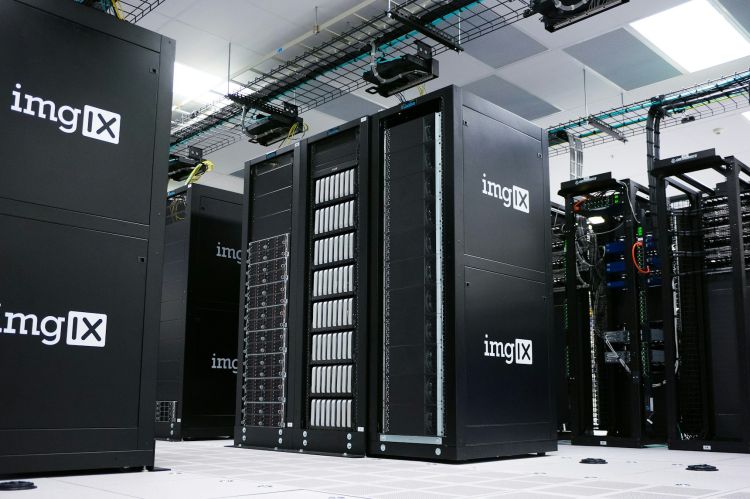 Rows of black server racks with white logos in a data center