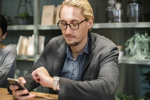 Man texting and looking at watch - Photo provided by rawpixel via Pixabay