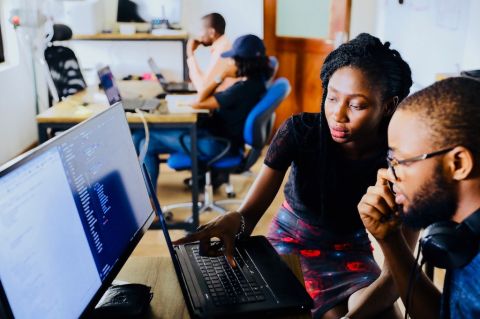 Office environment with people looking at their computer screens
