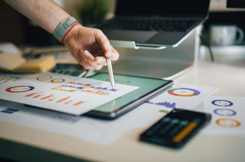 a person pointing to a piece of data visualized on a report