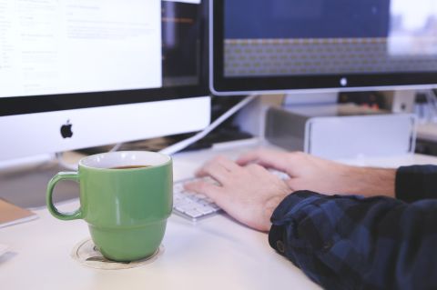 Person at keyboard with coffee cup. Image by StartupStockPhotos from Pixabay