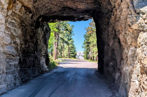 View through a tunnel from Iron Mountain Road in the Black Hills. Through the tunnel you can see Mt. Rushmore. Copyright 2026 by Bryan Ruby