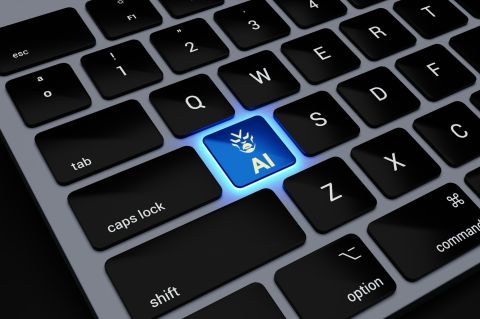 Closeup on a keyboard with an 'AI' key lit up blue