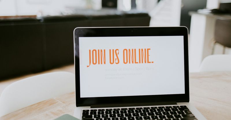 A laptop screen that reads "Join Us Online"