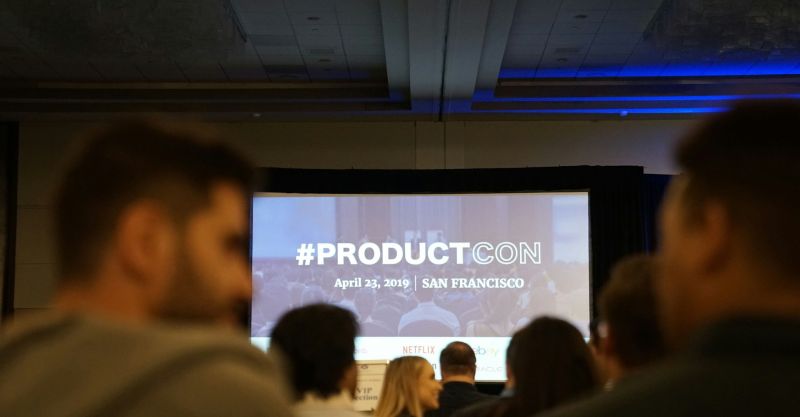 people in conference with projector screen in front