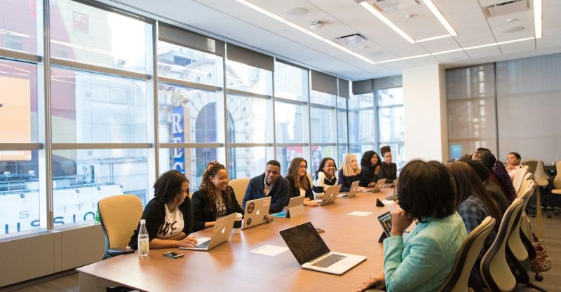A group of businesspeople sitting at a conference table.