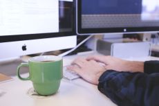 Person at keyboard with coffee cup. Image by StartupStockPhotos from Pixabay